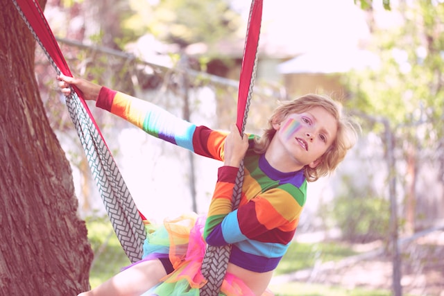 A gender non-conforming 10-year-old child playing outside.