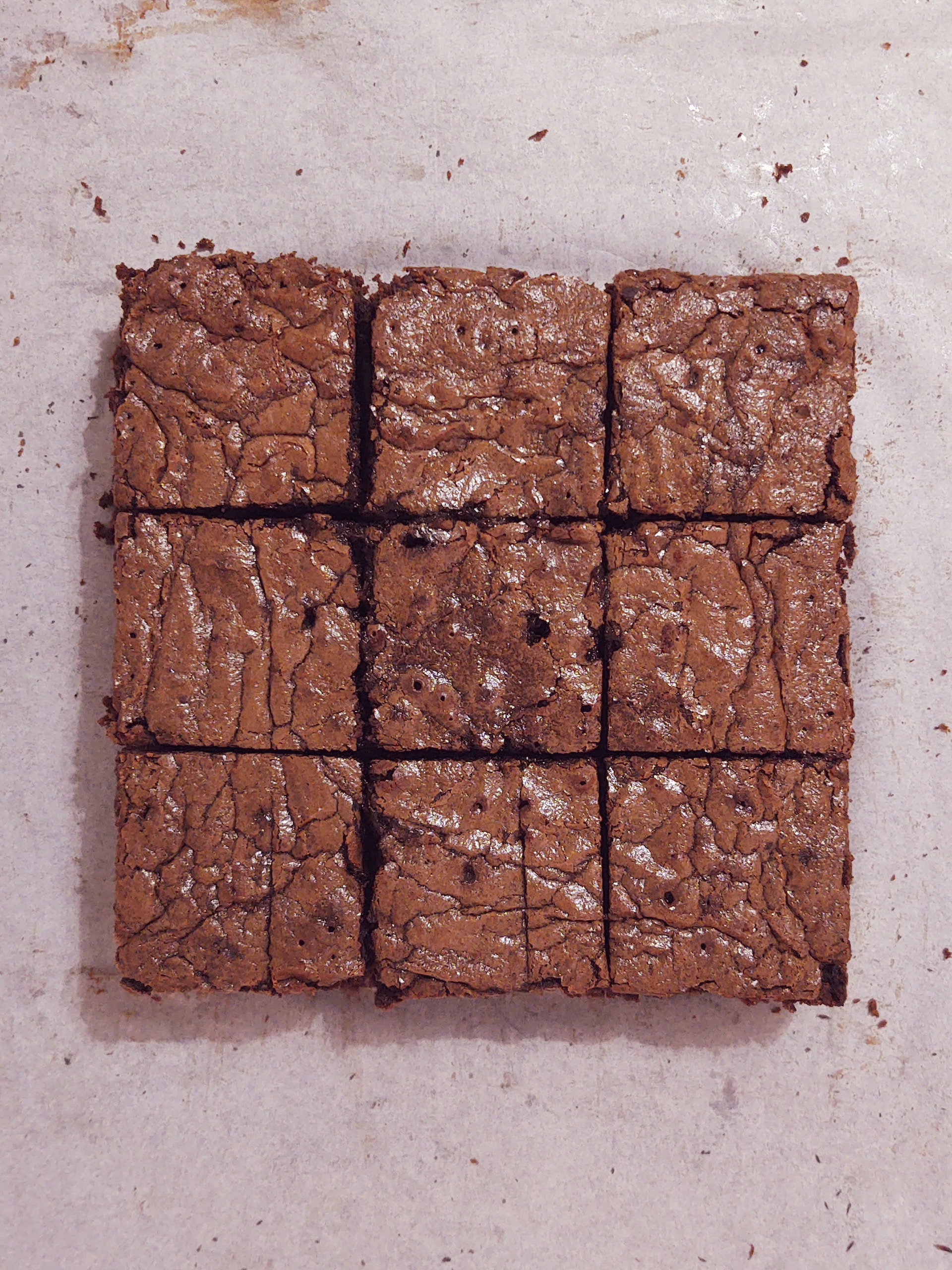 Nine squares of Fudge Brownies aranged into a larger square.