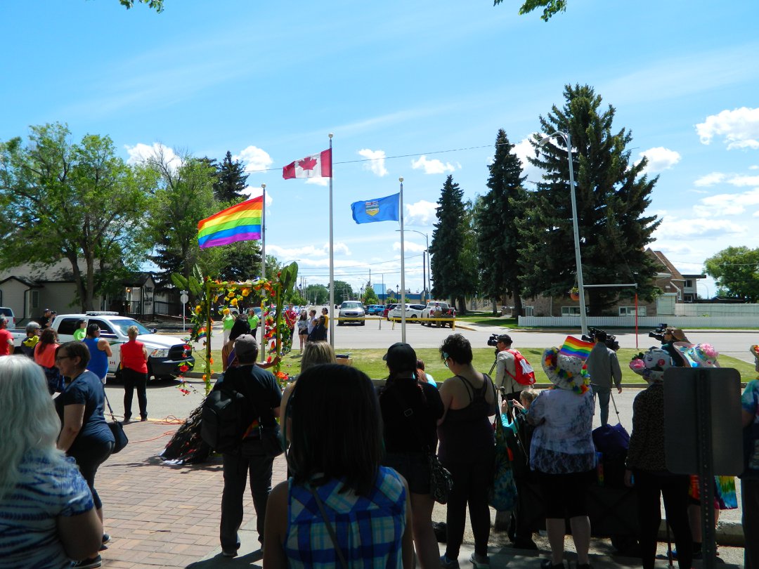 Photo of a group of people watching the Pride Flag raising on June 1, 2019.